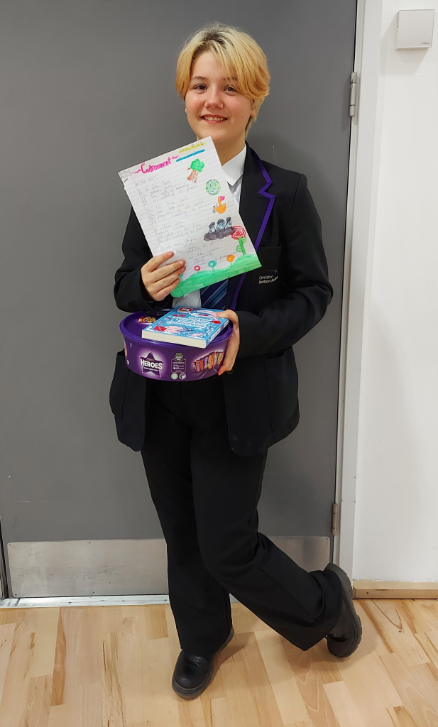 student poses with award